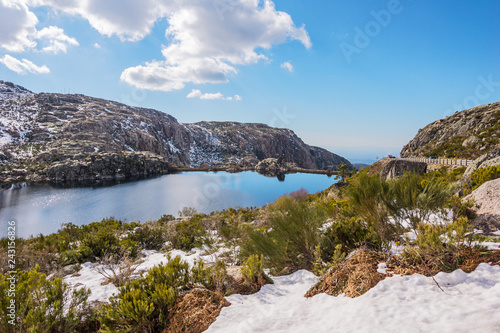 Snowy Mountains and Reservoir at Lagoa Comprida, a Lake In Serra da Estrela Natural Park in Central Portugal During Winter photo