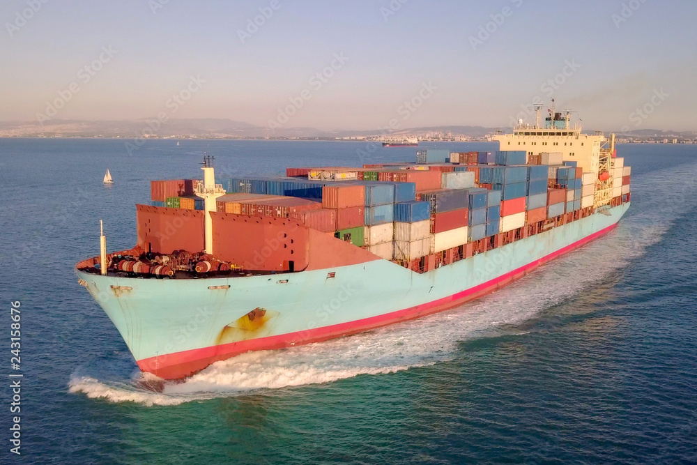 Aerial image of a large container ship at sea.