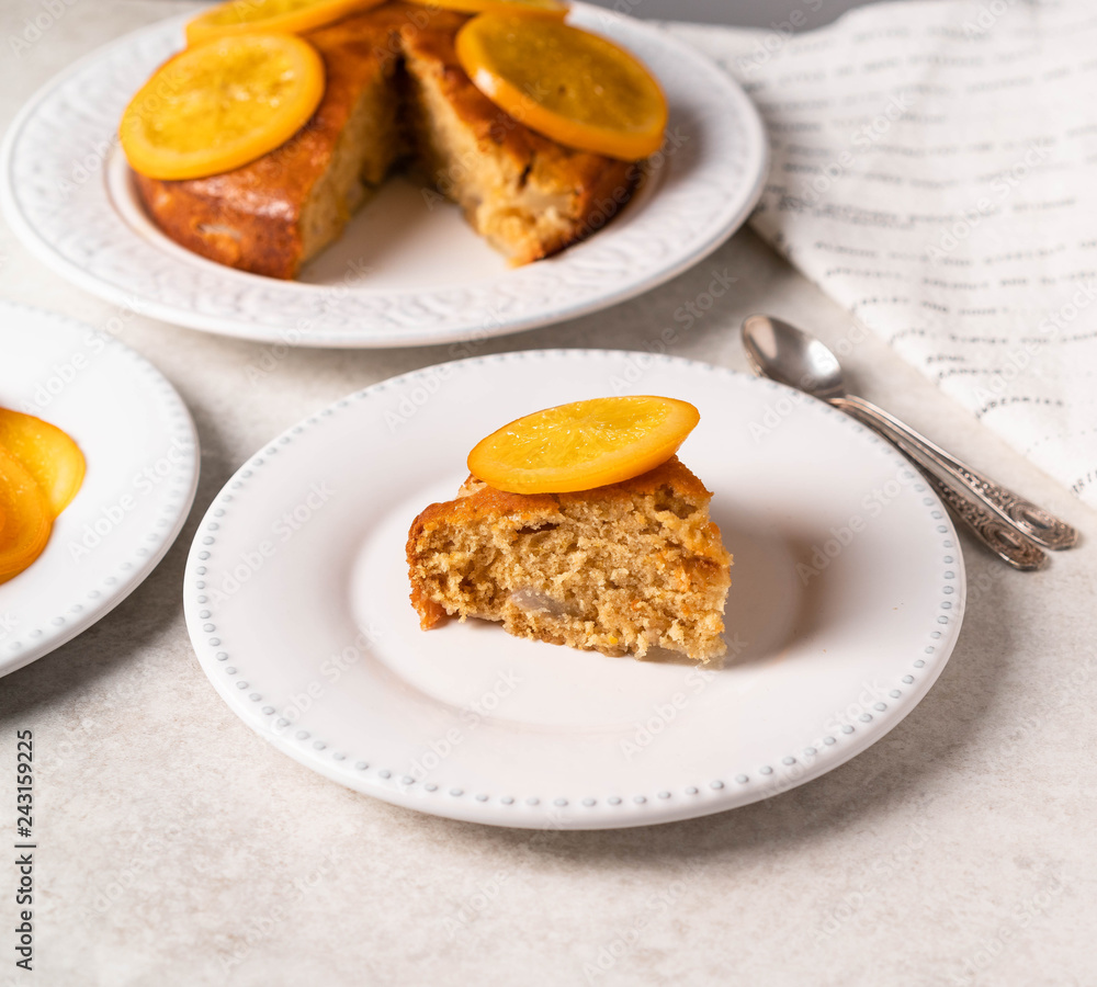 a dessert with orange and cardamom, on a white plate, light background