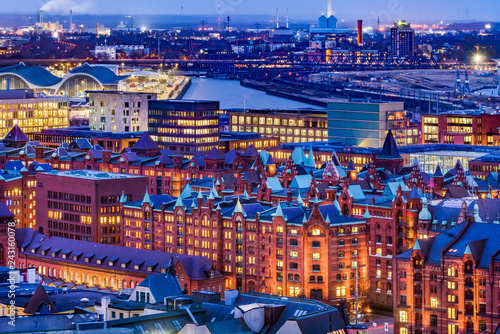 The Hamburg Warehouse District (German: Speicherstadt) and the harbor, Germany. Aerial view at dusk.