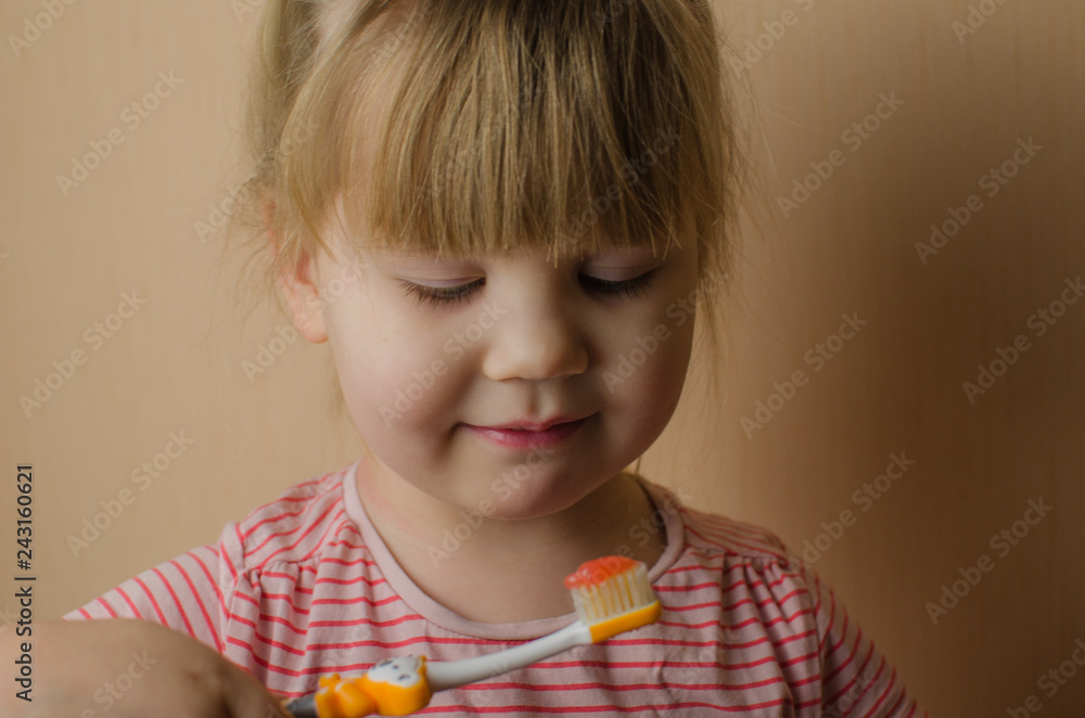 Happy little European girl brushing her teeth Happy little European girl brushing her teeth