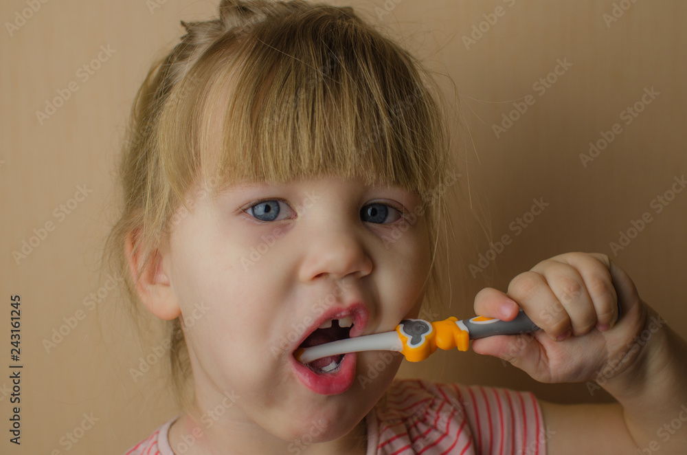 Happy little European girl brushing her teeth Happy little European girl brushing her teeth