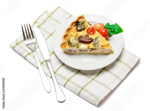 Slice of traditonal homemade spinach chicken quiche tart or pie on plate