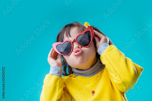Positive interested girl wearing weird big glasses in form of heart