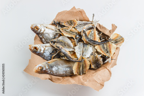Assorted dried fish in a basket on craft paper