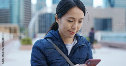 Photography Woman uses mobile phone in city