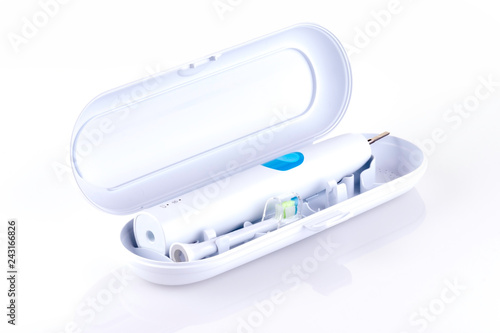 Ultrasonic toothbrush in travel box isolated on a white background with reflection and copy space. Dental concept. - Image
