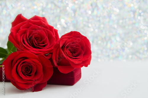 Three Red Roses and jewelery present box with boke Background. copy space - Valentines and 8 March Mother Women s Day concept.