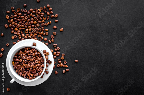 Coffee concept. Roasted beans on black background top view copy space