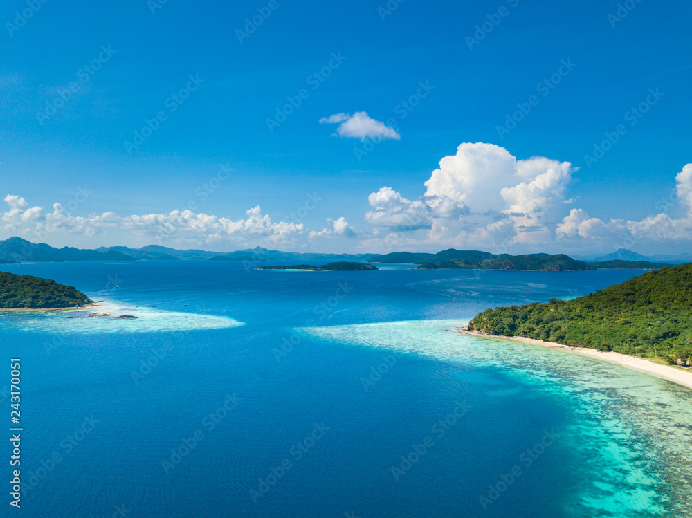 Aerial view of tropical island Bulalacao. Beautiful tropical island with white sandy beach, palm trees and green hills. Travel tropical concept. Palawan, Philippines