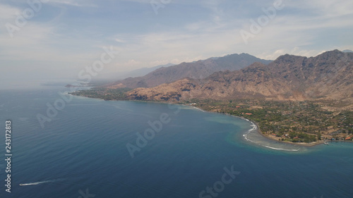 aerial tropical landscape town by sea, mountains, beach, boats on surface water. Bali,Indonesia, travel concept