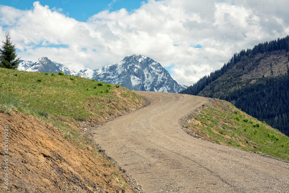 Zigzag dirt road with view on the Zugspitze mountain in Lahn, Austria.