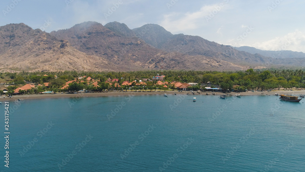 aerial tropical landscape town by sea, mountains, beach, boats on surface water. Bali,Indonesia, travel concept