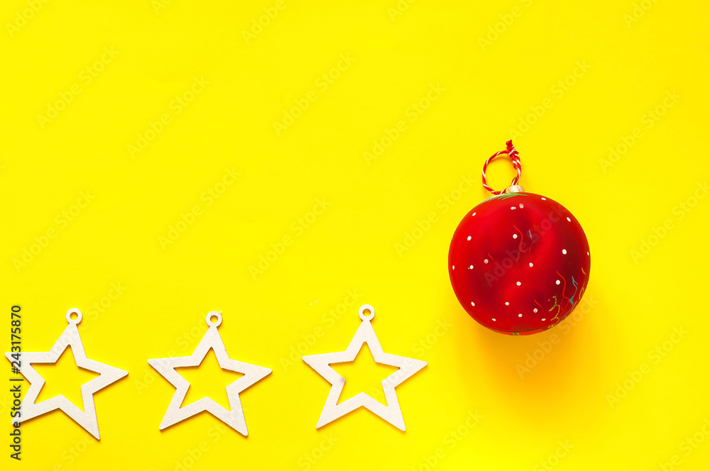 Christmas red ball on yellow background. The concept of the Chinese New Year. Festive backdrop for package and projects. Christmas red ball on yellow background. The concept of the Chinese New Year. Festive backdrop for package and projects.