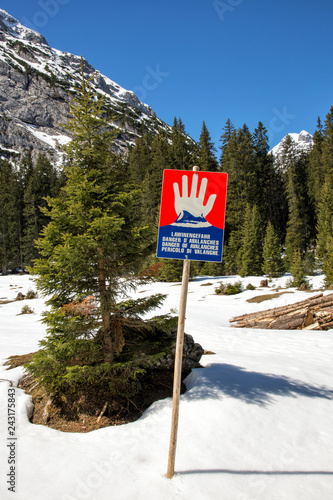 Bright red avalanche warning sign in the mountains around the town of Ehrwald, Tyrol, Austria. © Studio F.
