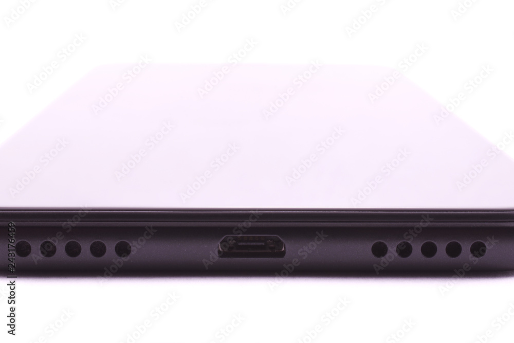 Black smartphone, edge with micro usb charger connector and speakers Black smartphone, edge with micro usb charger connector and speakers