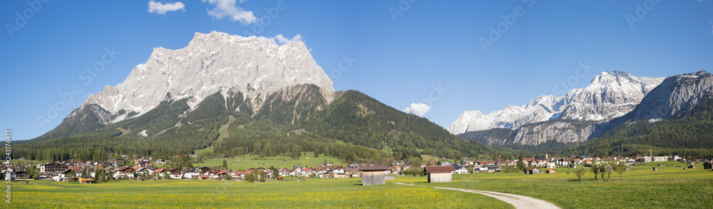Panoramic view on the village of Ehrwald (Austria) and its beautiful surrounding mountains and meadows. Shot in  afternoon sunlight.