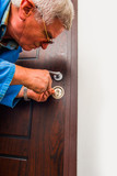 Repairman repair the door lock