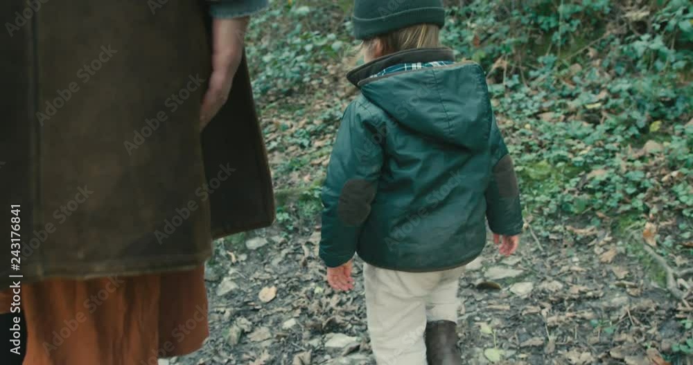 Little toddler walking in forest with mother and grandfather Little toddler walking in forest with mother and grandfather