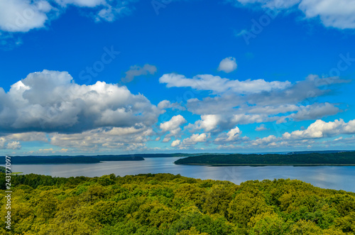 View over forests on the island of Rügen, Germany, on dramatic clouds towering over the water.