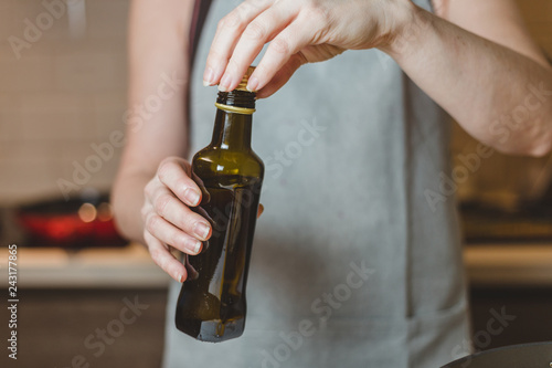 Closeup of hands pouring virgin olive or sunflower oil