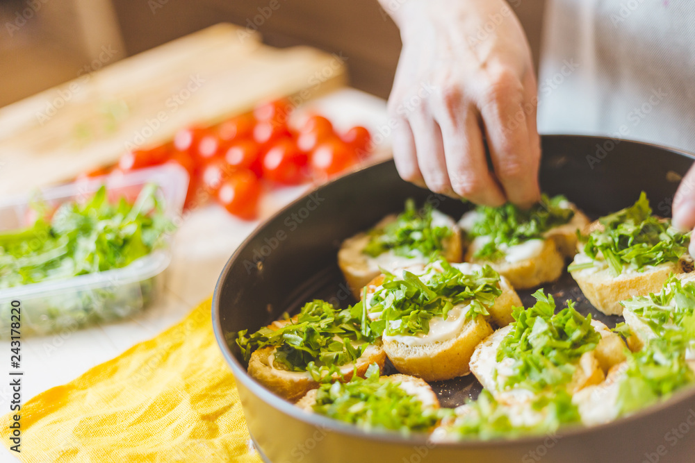 Close up of senior woman hands cutting baguette - making sandwich bruschetta - home cooking Close up of senior woman hands cutting baguette - making sandwich bruschetta - home cooking