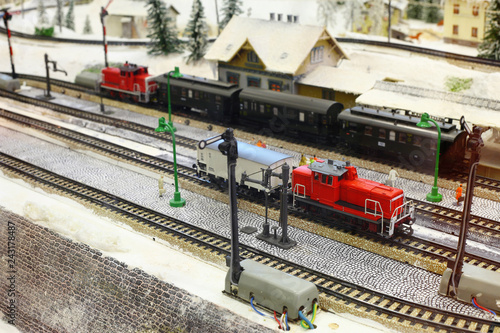 Train models and railroad tracks with winter scenery photo