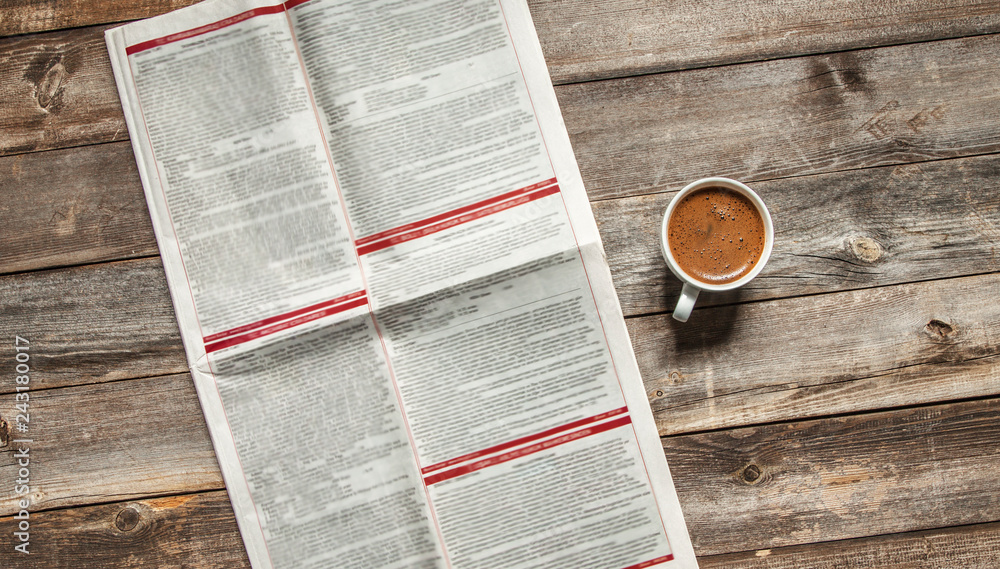 Fototapeta premium Reading newspaper on wooden background