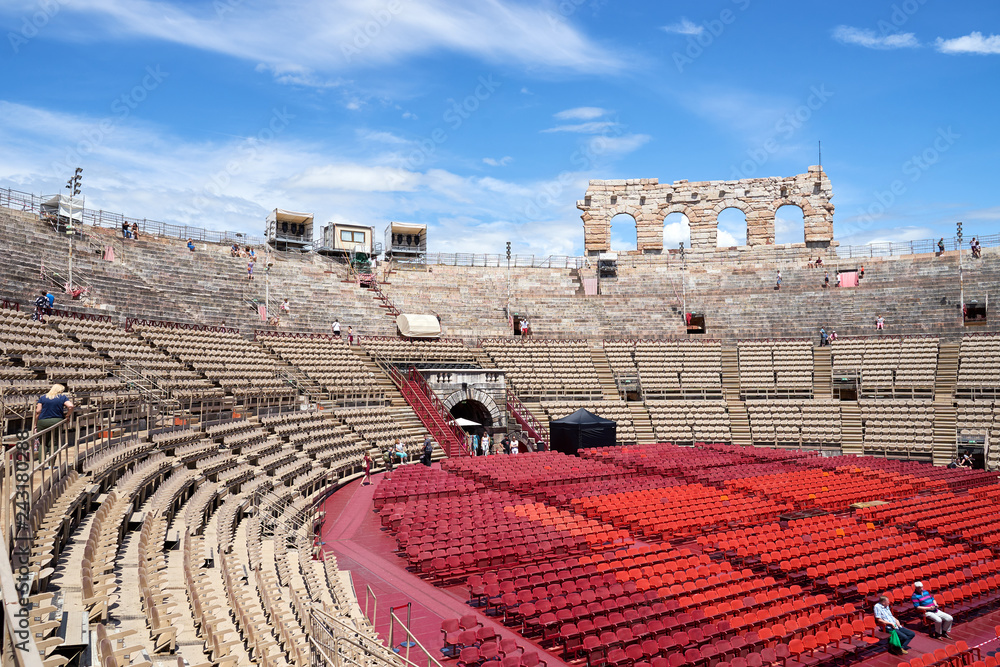 Φωτογραφία Inside of Arena of Verona in Italy / 
Red seats under blue sky in the theater