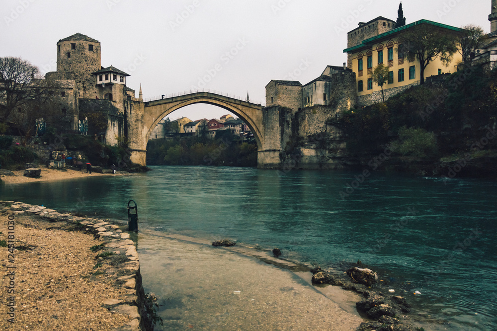 Historic Mostar Bridge on cloudy day