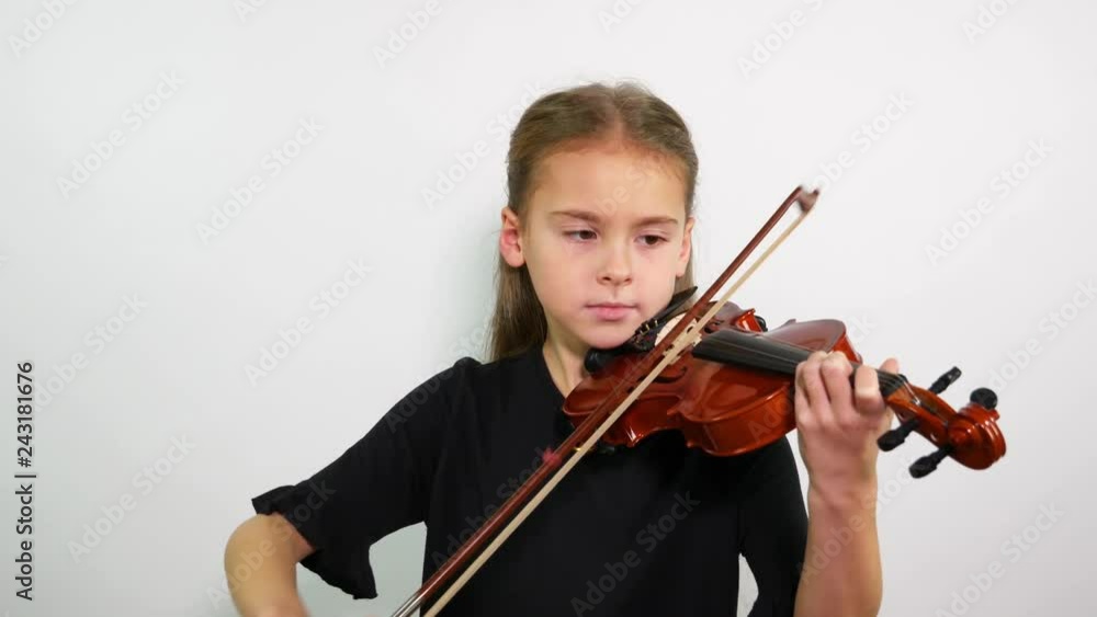 Violin lesson. The face of a girl playing a violin song. Violin lesson. The face of a girl playing a violin song.