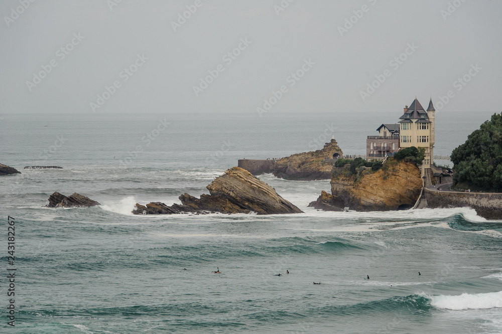 FRANCE, BIARRITZ - SEPTEMBER 18, 2018: Modern castle situated by the sea with cliffs and seagulls on windy day