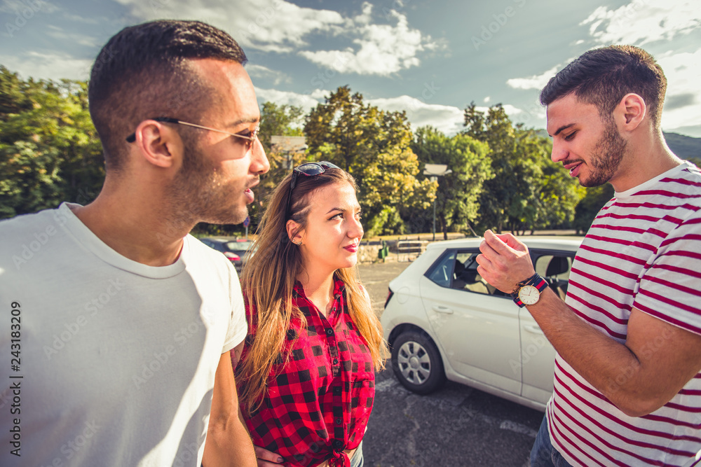Group of people standing outside at parking lot Group of people standing outside at parking lot
