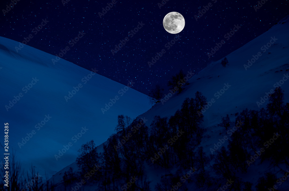Majestic winter night in a mountain valley with full moon in a starry sky. Majestic winter night in a mountain valley with full moon in a starry sky.