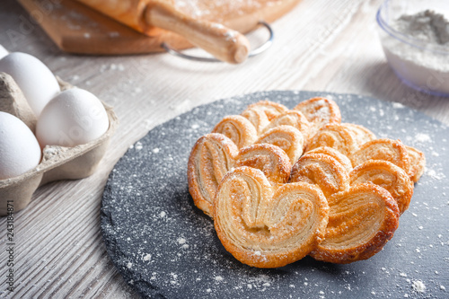 Puff pastry eyelet on slate Board, sprinkled with powdered sugar or flour. photo