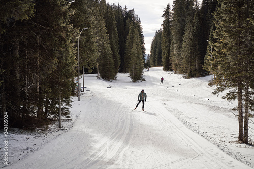Caucasian man enjoying his free time cross country skiing in the woods, covered with snow © SVP Productions