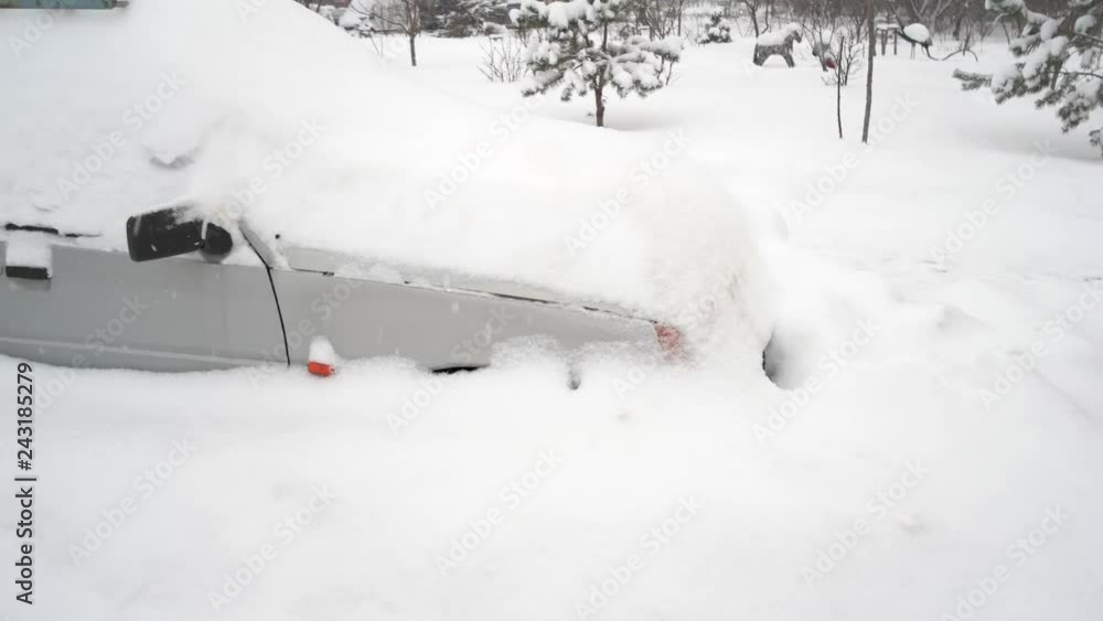 Passenger car after snow storm. Car buried under deep snow after snow storm. How cold temperatures affect your car. Passenger car after snow storm. Car buried under deep snow after snow storm. How cold temperatures affect your car.