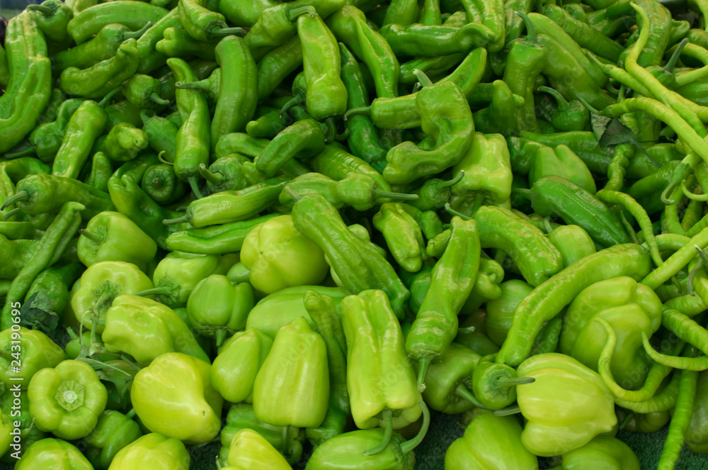 Close up of group of fresh green peppers at a farmers market. Healthy food. Organic background Close up of group of fresh green peppers at a farmers market. Healthy food. Organic background