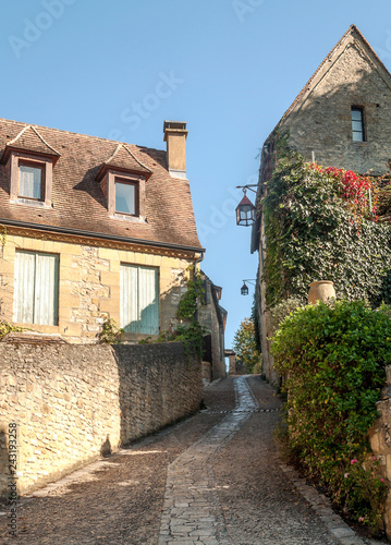 Medieval village of Aquitaine with its stone houses in the south of France on a cloudy day. © Tomas