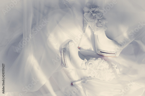 .Beautiful bride shoes on a white fot. photo