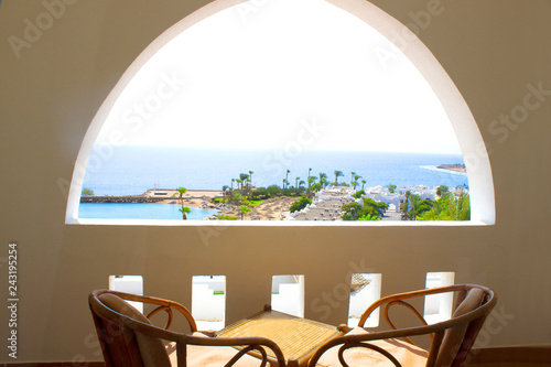 Sea view terrace with a table and chaires photo