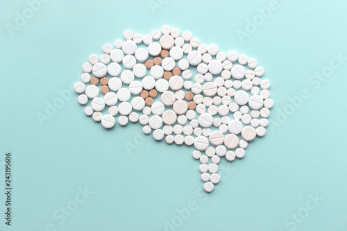 Brain made of pills on light mint background. Top view. Multiple sclerosis day concept.