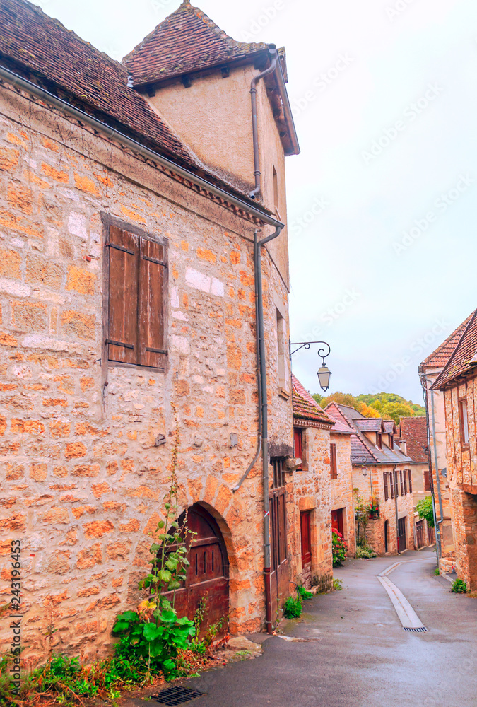 Medieval village of Aquitaine with its stone houses in the south of France on a cloudy day.