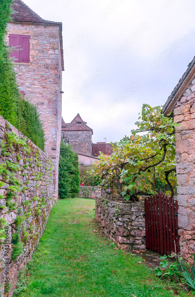 Medieval village of Aquitaine with its stone houses in the south of France on a cloudy day.