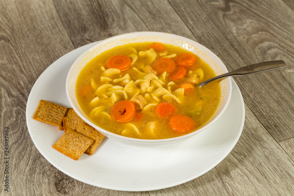 Bowl of Chicken Noodle Soup with Crackers Bowl of Chicken Noodle Soup with Crackers