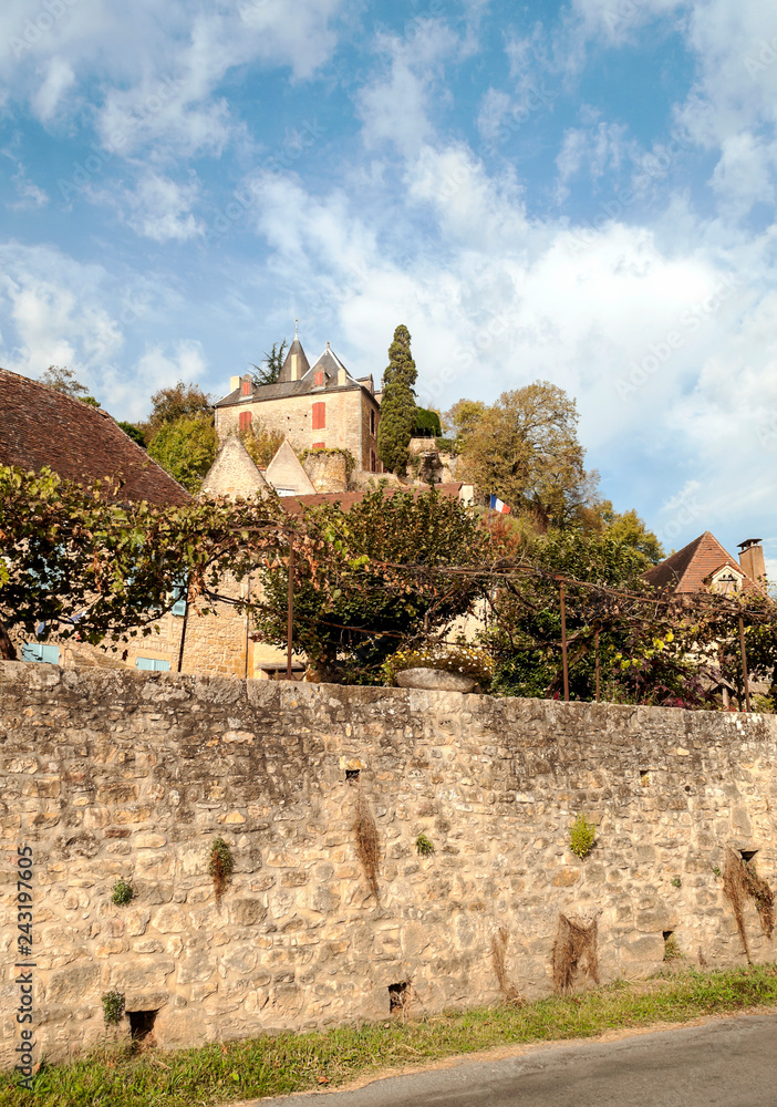 Medieval village of Aquitaine with its stone houses in the south of France on a cloudy day.