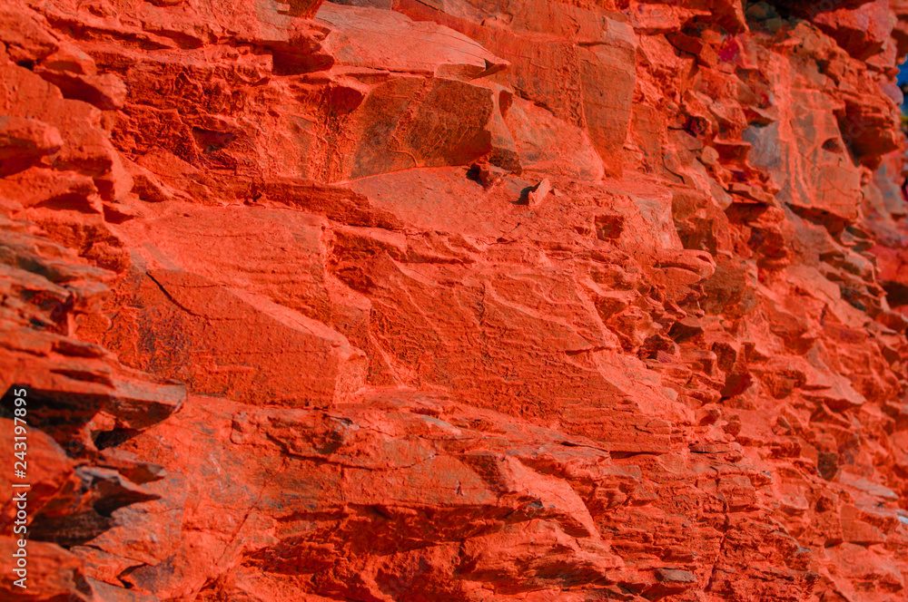 Surface with a texture of red stone. Designer background for interiors. Stone surface of a red rock. Surface with a texture of red stone. Designer background for interiors. Stone surface of a red rock.