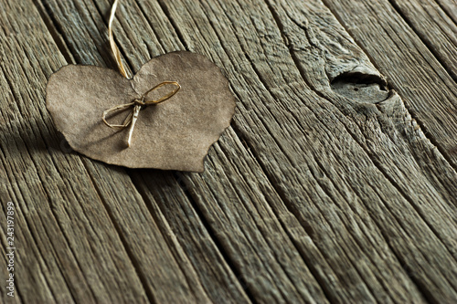 Brown paper Heart  on wooden backdrop. Happy valentines day. St. Valentine background. Holidays greeting card copy space