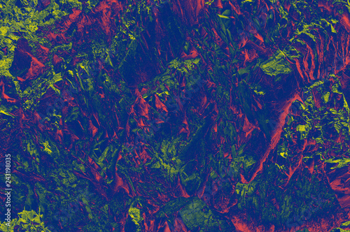 Colorful (red, pink, yellow, and purple) stone mosaic tiles on the wall as background or texture