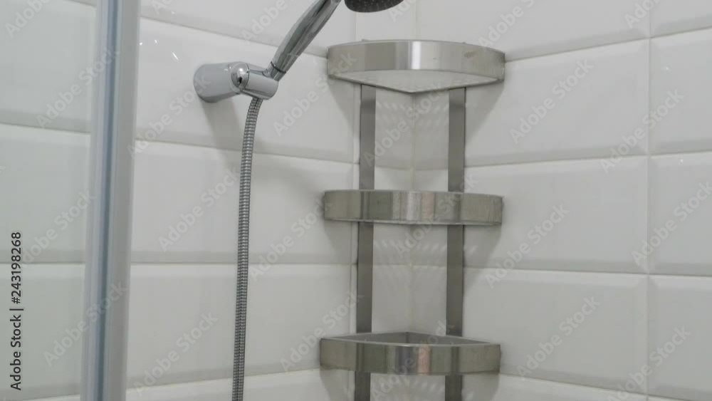 Modern bathroom interior. Empty shower cabin with white tiled walls and shelves. View from top to bottom. Modern bathroom interior. Empty shower cabin with white tiled walls and shelves. View from top to bottom.
